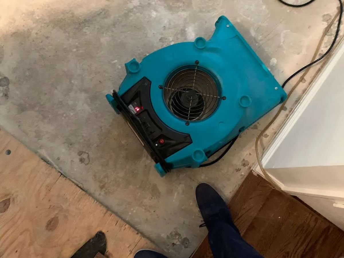 Air mover drying subfloor during Leak Detection & Repair in North Adams